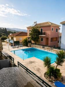 a swimming pool in front of a house at Zen Villas in Nikiana