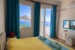a bedroom with a bed and a large window at Goknar Knidos Nature Hotel and Farm in Datca