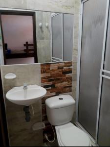 a bathroom with a toilet and a sink and a shower at Casa Rotario Honda in Honda
