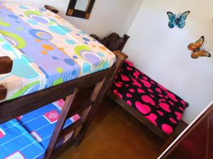 a bedroom with a bunk bed and a butterfly on the wall at Casa Rotario Honda in Honda
