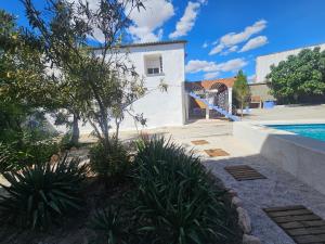 a villa with a swimming pool and a house at El Patio de Doña Tere in Villarta de San Juan