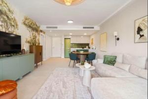 a living room with a couch and a table at Palm Forest Oasis in Mijas Costa