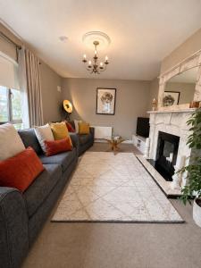 a living room with a couch and a fireplace at The Hillcrest, Luxury Accommodation in Castleblayney Town in Castleblayney