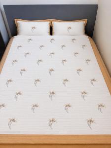 a bed with a bedspread with brown spiders on it at Garden suite in Vancouver