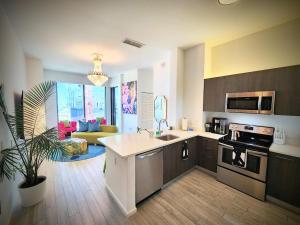 a kitchen with a sink and a stove top oven at Marina Miami Penthouse- Downtown-Brickell 2BD-2BA in Miami