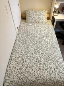a bed in a room with a bedspread on it at Garden suite in Vancouver