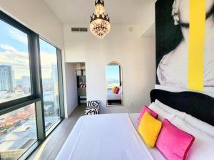 a bedroom with a large white bed with colorful pillows at Marina Miami Penthouse- Downtown-Brickell 2BD-2BA in Miami +54 photos