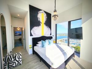 a bedroom with a bed with a large painting on the wall at Marina Miami Penthouse- Downtown-Brickell 2BD-2BA in Miami