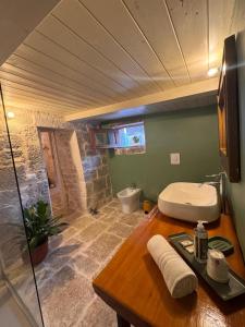 a bathroom with a sink and a toilet at Trullidea in Alberobello