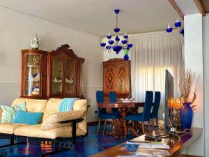 a living room with a couch and a table at The Dreamer's Terrace in Vico Equense +22 photos