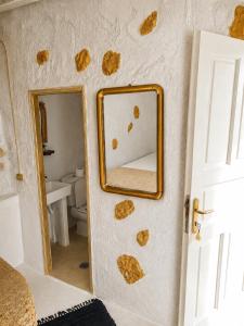a bathroom with a mirror on the wall at Artemis Cottage Authentic Mykonian Stone House near Super Paradise in Super Paradise Beach +44 photos