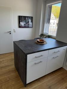 a kitchen with a island with a black counter top at Chalet Relax in Birresborn +9 photos