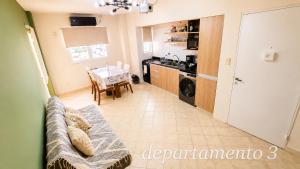 a living room with a couch and a kitchen at Nice Full Apartments Downtown Salta in Salta +11 photos