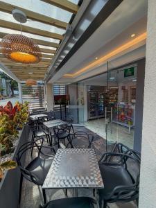a restaurant with tables and chairs in a building at Hotel Aikos in Yumbo