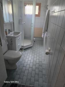 a bathroom with a shower and a toilet and a sink at Mudita Apartment in Mikkeli +13 photos