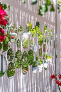 a bunch of glass mirrors on a wall with flowers at Sunmed Lodge in Oludeniz