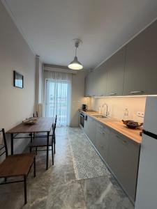 a kitchen with a table and a dining room at City View Apartment in Mytilene