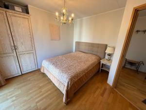 a bedroom with a bed and a chandelier at Masti Apartment in Tallinn