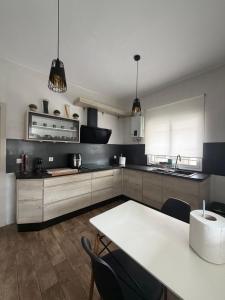 a kitchen with a table and some chairs in it at Chalet Escapada in Seville