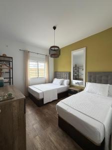 a hotel room with two beds and a mirror at Chalet Escapada in Seville +19 photos