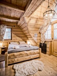 a bedroom with a bed in a wooden cabin at Zakopane Best in Zakopane