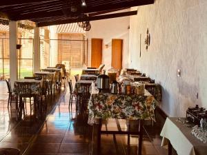 a row of tables and chairs in a room at Pousada Sol & Mar Jacaraìpe ES in Serra