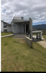 a building with a grassy yard in front of it at Casa Mirador del Lago in Villa Parque Siquiman