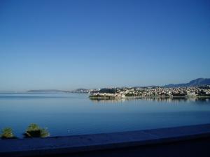 a view of a large body of water with a city at Pink Inn in Podstrana