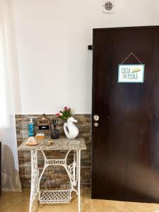a black door with a sign on it next to a table at Casa da Pedra in Moledo
