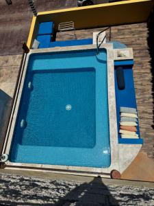 a blue swimming pool sitting on top of a building at Casa Velero Puerto Morelos in Puerto Morelos