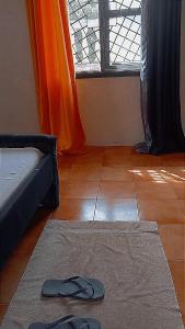 a pair of slippers on the floor in a room with a window at Honeymoon villa Diani in Diani Beach