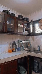 a kitchen with wooden cabinets and a counter top at Honeymoon villa Diani in Diani Beach +13 photos