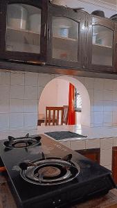 a kitchen with a stove top oven in a kitchen at Honeymoon villa Diani in Diani Beach