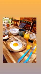 a wooden table with an egg on top of a sandwich at Cocon-ardechesauvage in Pont-de-Labeaume +4 photos