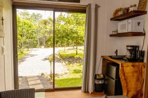 a kitchen with a sliding door to a yard at Secret Hideaway in Guápiles