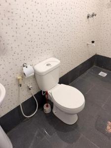 a bathroom with a white toilet and a sink at Summer Malindi Family House in Malindi +11 photos