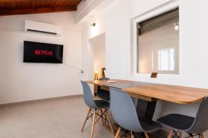 a dining room with a wooden table and chairs at Dorothy's Apartments Near Athens Airport By SEM in Artemida +12 photos