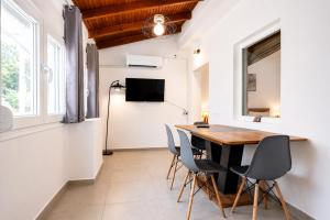 a dining room with a table and chairs at Dorothy's Apartments Near Athens Airport By SEM in Artemida