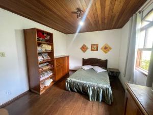 a room with a bed and a shelf with shoes at Cozy Farmhouse with Pool in Bom Jardim in Bom Jardim +35 photos