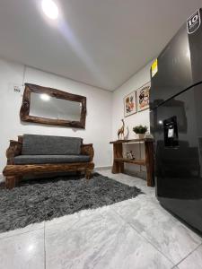 a bedroom with a bed and a mirror on the wall at Apartamento amoblado Chinchina in Chinchiná
