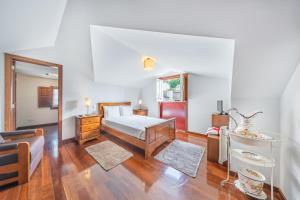 a bedroom with a bed and a mirror in it at Casa da Obrinha in Bouro