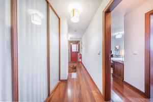 a hallway of a home with white walls and wooden floors at Casa da Obrinha in Bouro +59 photos