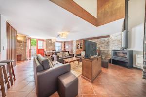 a living room with a couch and a fireplace at Casa da Obrinha in Bouro