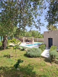 a backyard with a swimming pool and a house at Stones villa corfu in Varypatádes