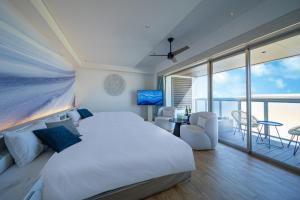 a bedroom with a large bed and a balcony at THE ZK West Coast in Awaji +86 photos