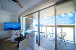 a living room with a view of the ocean at THE ZK West Coast in Awaji