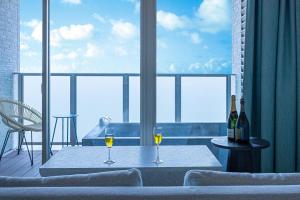 two glasses of wine sitting on a table on a balcony at THE ZK West Coast in Awaji