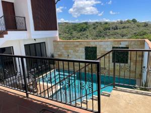 a balcony of a house with a swimming pool at Hotel Lengerke Barichara in Barichara
