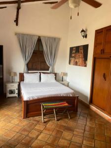 a bedroom with a bed and a bench in it at Hotel Lengerke Barichara in Barichara +47 photos