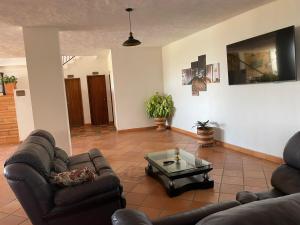 a living room with two couches and a coffee table at Hotel Lengerke Barichara in Barichara
